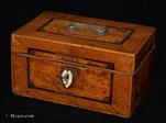 736MB: A box in a striking combination of ash and ice-birch veneers, banded and delineated, with a carrying handle on the top and bone escutcheon. Circa 1780 