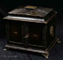 JB423: Antique Regency Table cabinet of architectural form the complex shape covered with embossed and tooled leather. The cabinet has double doors to the front which open to reveal a nest of drawers covered with tan coloured leather. The cabinet stands on embossed  brass feet and has embossed brass ring handles. There is a secret compartment in the top. Circa 1820. 
