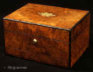 Antique ebony edged box in highly figured burr walnut having a Bramah type lock and a sprung drawer of dovetail construction fitted for jewelry and a lift out tray. The drawer is held in place by a brass pin driven through the facing. In the top section there is a lift-out compartmentalized tray. In the lid there is a document wallet. Enlarge Picture