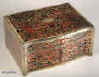JB315: Boulle box in brass and red tortoiseshell having a serpentine front. and engraved brass and Boulle in red tortoiseshell depicting stylized scrolling  floral motifs to top sides and front.   The box is lined with silk and velvet. Circa 1840. Enlarge Picture