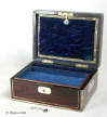 A rosewood veneered box, with brass surround and brass inlaid lines and inset brass handles.  Circa 1840.