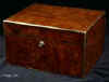 JB417: A very large Victorian box veneered in burr walnut of exceptionally dense figure displaying the ripples and swirls naturally occurring in parts of the log obtained from carefully coppiced wood near the stump of the tree. The box has a superior hinge which deals with the weight of its size. When open it is supported by rounded links within the hinges. The box has been fitted with two lift out trays. Tiny chips and some dents to the veneer seen when the box is closely examined. They disappear into the complex figure when overviewed. Bramah working lock and key. Circa 1860. Enlarge Picture