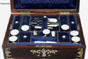 SB120: A fully fitted sewing box veneered in thick striated coromandel  and inlaid in brass and shell, both mother of pearl and abalone. Inside there is the original fitted liftout tray  lined with silk and velvet, with a set (6)  of carved and turned mother of pearl daisy pattern spools designed for the new thread which now came on wooden reels.  The tray also has supplementary lids with carved mother of pearl pulls.   The box also has period  sewing tools including penknife button hook, and tweezers, and bodkin with mother of pearl handles. The steel scissors is designed for cutting button holes.  There is a document wallet in the lid. Circa  1870. Enlarge Picture