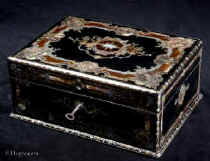  SB500: Antique opulent fully fitted sewing box in ebony profusely inlaid with tortoiseshell,  engraved brass, mother of pearl and abalone. The inside has  a silk covered lift out tray retaining a set of sewing tools  including turned and carved mother of pearl spools with matching tape measure and needle cleaner. A central tray has steel tools with tortoiseshell handles. Circa 1840.   Enlarge Picture