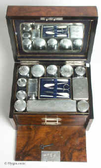 A dramatic high quality figured walnut  dressing box with chassed silver plate top crystal bottles and drop front Circa 1895