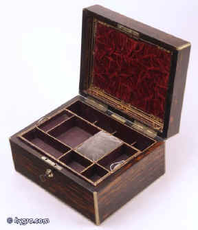 JB310:A  brass edged coromandel jewelry box, by H. Trussell of Brighton the hinged lid opening to reveal a velvet and gold embossed lined interior and two lift-out trays. The box has a working Bramah lock and key. Circa 1840.  Enlarge Picture