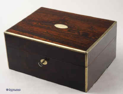  JB311: Brass edged figured rosewood box with brass escutcheon and a brass plate, having a lift out tray. The box has a document wallet with gold and blind embossing to the lid and a working lock and key. Circa 1830 Enlarge Picture