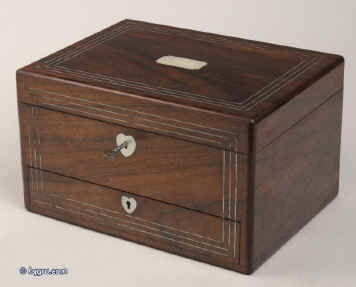 JB313: A figured rosewood veneered box with rounded edges, white metal (pewter) and mother of pearl accents having two liftout trays fitted for jewelry. Inside the lid is lined with ruched satin framed with gold embossed leather and opens down to  a document wallet. The lower drawer which is separately locked using the same key as the box,  is a writing box with Tyrian purple writing surface compartments for writing implements and paper. Circa 1845. Enlarge Picture