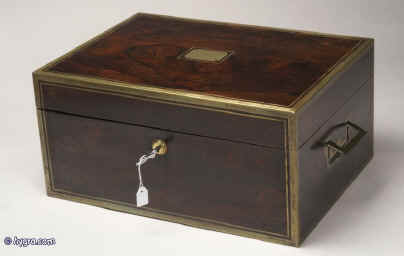 JB317: A  very fine and rare brass bound figured rosewood fully fitted traveling/dressing box by D Edwards, with working Bramah lock and countersunk carrying handles, the inside lined in velvet and gold embossed  leather and containing hallmarked silver toped cut lead crystal bottles and jars by Archibald Douglas and having a document wallet and liftout mirror in the lid. Circa 1829.  Enlarge Picture