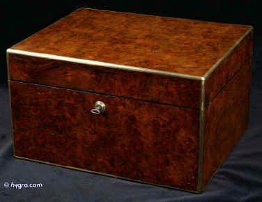 JB417: A very large Victorian box veneered in burr walnut of exceptionally dense figure displaying the ripples and swirls naturally occurring in parts of the log obtained from carefully coppiced wood near the stump of the tree. The box has a superior hinge which deals with the weight of its size. When open it is supported by rounded links within the hinges. The box has been fitted with two lift out trays. Tiny chips and some dents to the veneer seen when the box is closely examined. They disappear into the complex figure when overviewed. Bramah working lock and key. Circa 1860. Enlarge Picture