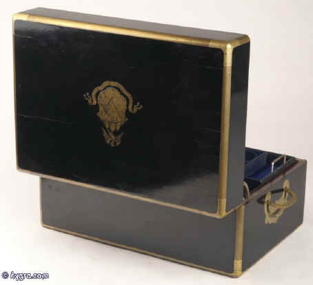 JB420: Brass bound French ebonized box by L. Aucoc aine, Paris with inlaid armorial Achievement for Bingham/ Pemburton/ Chaldicott. The box has a working Bramah lock, opening to a leather and silk covered compartmentalized interior. There are compartments and small containers which fit snugly into their allotted spaces. There is also a secret sprung drawer. Everything is covered in original leather and silk. The hinge is heavy allowing for the weight of the box. It also has the self supporting structure which helps the heavy lid stay open. Circa 1860. Enlarge Picture