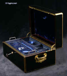 JB420: Brass bound French ebonized box by L. Aucoc aine, Paris with inlaid armorial Achievement for Bingham/ Pemburton/ Chaldicott. The box has a working Bramah lock, opening to a leather and silk covered compartmentalized interior. There are compartments and small containers which fit snugly into their allotted spaces. There is also a secret sprung drawer. Everything is covered in original leather and silk. The hinge is heavy allowing for the weight of the box. It also has the self supporting structure which helps the heavy lid stay open. Circa 1860. Enlarge Picture