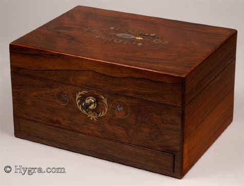 JB434: Figured Rosewood dressing box with rounded edges and inlays of mother of pearl and metal working Bramah lock with key, the box made by Joseph Mechi, London, the interior still fitted with dressing accessories in cut glass and hallmarked (1875)  silver by  Frances Douglas and John Howes. The box has a sprung lower drawer fitted for jewelry and a document wallet covered with ruched velvet framed with gold embossed leather in the lid. There is a lift out tray having further divisions and lids and a further compartment beneath for jewelry. Circa 1875. Enlarge Picture