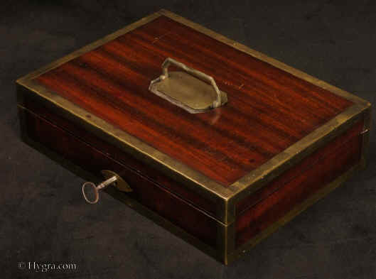  Description: JB502 A brass bound mahogany gentleman's campaign  dressing box by D. Edwards, Holborn, London the compartmentalized interior with supplementary lids, all  lined with red embossed Morocco leather and containing steel boot-strap pullers pewter containers for ointments and shaving soap (P & R Hendri)  a bone shaving brush,  razors, and for sharpening "S. ESTCOURT'S CRITERION STROP" Circa 1810. Enlarge Picture