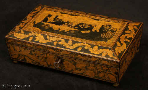 JB552: Penwork box with tapering sides and pyramided top, the sides depicting floral themes, the top a scene from oriental life with figures in a garden, and fantastical insects. The inside is compartmentalized to hold playing cards and counters. The arrangement makes it ideal also as a jewelry or trinket box. The box stands on ball feet.  circa 1820.  Enlarge Picture