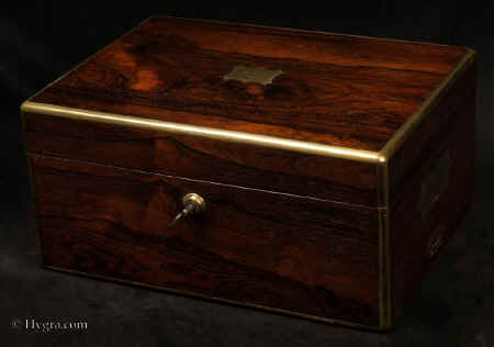 JB554:Georgian brass edged figured rosewood box with compartmentalized  interior and side drawer fitted for jewelry. The box has a working Bramah lock with key and a document wallet to the lid. Circa 1820. Enlarge Picture