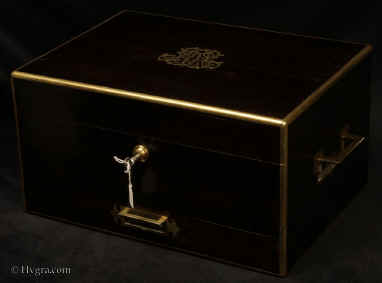 JB555: A particularly large brass edged  top quality box veneered with almost black coromandel (ebony)  and having inset brass carrying handles  Bramah lock  which also secures the drawer. The box retains its original velvet lined liftout tray.There is a silk lined tooled leather document wallet in the lid as well as a framed mirror and a space for another mirror. The box is lined with its original leather and velvet. Circa 1850. Enlarge Picture