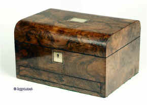 A richly figured burr walnut dome top box with liftout tray and  sprung drawer fitted for jewelry. Enlarge Picture
