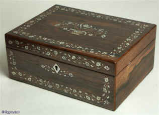 A mid Victorian rosewood box inlaid with mother of pearl, abalone, and metal, depicting flowers, having a velvet lined liftout tray and wallet for letters. Enlarge Picture