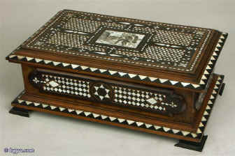  Antique Italian Casket in the Renaissance Classical Revival Manner. The box is made of walnut with raised panels of ebony. It stands on a a platform base which is supported on ebony bracket feet. The lid protrudes to the same extent as the base giving the box an imposing structure. Enlarge Picture