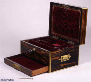 Antique box veneered in strongly figured  coromandel, with brass edging, central  plate. It is  high quality, made by Briggs, Manufacturer, of 27 Piccadilly London  which continues into the interior. It is lined in velvet, silk and gold embossed leather. It has a lift-out tray and sprung drawer.  circa 1840 Enlarge Picture