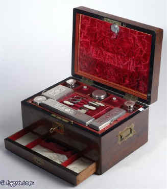 Early Victorian rosewood fitted dressing box of fine quality  by  Promoli & Hausburg  of Liverpool,  with engraved and fretted silver topped bottles (hallmarked London 1842-3) having a drawer for jewelry.