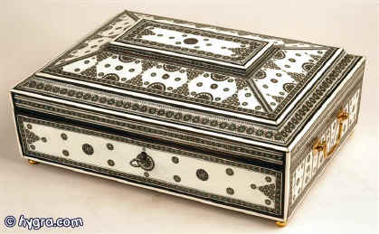 Anglo Indian sandalwood box veneered with ivory panels framed with sadeli mosaic and inlaid with sadeli mosaic standing on gilded feet and having a liftout tray with supplementary lids Circa 1830  Enlarge Picture