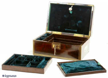 A brass edged rosewood box having two velvet lined liftout trays of rosewood construction and document wallet with high security Chubb detector lock. The box is beautifully constructed in highly figured rosewood having solid rounded brass edgings and inset handles. The ruched and plain velvet  are all original. Circa 1840. Enlarge Picture