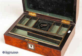 An elegant compact mid 19th century domed top figured walnut box fitted for jewelry with divisions in embossed leather and linings in green velvet and silk  circa 1860 Enlarge Picture