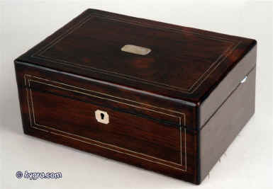 A Victorian figured  rosewood box with rounded edges inlaid with white metal and having a mother of pearl escutcheon retaining its original liftout tray which has been relined with red velvet and having a blind embossed leather document wallet to the lid. circa 1860 Enlarge Picture