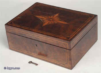 Antique late 18th C  Rosewood veneered box with replacement velvet lined liftout tray, inlaid to all sides with a framing  of boxwood  lines the top of book-matched  rosewood inlaid with a central panel of marquetry depicting a stylized sunflower.  Enlarge Picture