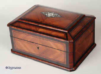 JB219: A mid 19th Century classically shaped and structured  French box elaborately veneered with a parquetry of kingwood, rosewood,  tulipwood and ebony, having a replacement lift out tray fitted for jewelry. The lid retains its original  blue button quilted lining Circa 1840. Enlarge Picture