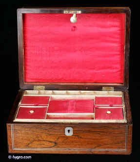 SB402: A Victorian figured  rosewood box  by Mechi of London. with rounded edges inlaid with white metal and having a mother of pearl escutcheon retaining its original liftout compartmentalized tray with supplementary lids  and having a  document wallet to the lid. circa 1840 Enlarge Picture