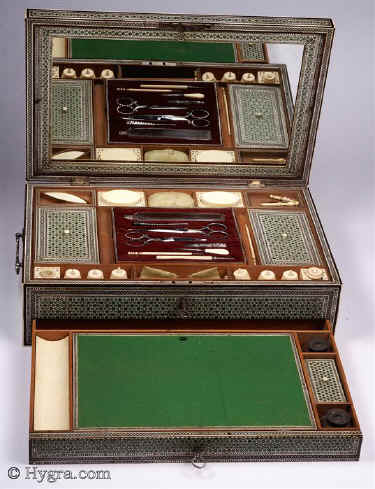 SB432: Important, rare,  first period sadeli mosaic  fully fitted combined sewing  and writing box, retaining original turned ivory sewing tools.  The box has a  retailers label: HALSTAFF AND HANNAFORD  but would have been made in Bombay India circa 1800. It is probable that the retailer/ London maker arraigned for the sewing fittings in the central tray. It was not unusual for boxes to be adjusted for the client. Circa 1800. Enlarge Picture