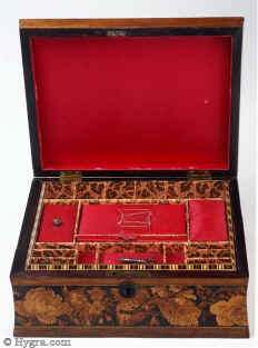 SB440: A rosewood veneered Tunbridge ware  Sewing box, the slightly domed top inlayed with a display of roses depicted in micro mosaic, framed by  a wide banding of Berlin wool-work in micro mosaic and bandings of contrasting light and dark wood; there is a further banding of Berlin wool work design encircling the box which has concave sides. The inside retains its original liftout tray which is lined with its original  paper. Inside the lid is lined in red silk. circa 1850 Enlarge Picture