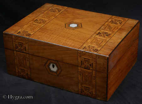 SB480: Walnut veneered box  inlaid  with bandings of parquetry circa 1880. A box of pleasing structure with a relined interior. The inlay is within the genre of mid to late 19th century, but it has greater complexity than the average example of such work. Working lock and key. Enlarge Picture