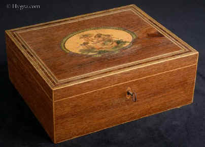 SB 493: A rare Georgian sewing box of rectangular form  edged with maple the top having a hand colored print depicting cherubs and framed with mitered purfling having a lift-out tray still retaining turned Tunbridge ware whitewood sewing tools. Circa 1800. Enlarge Picture