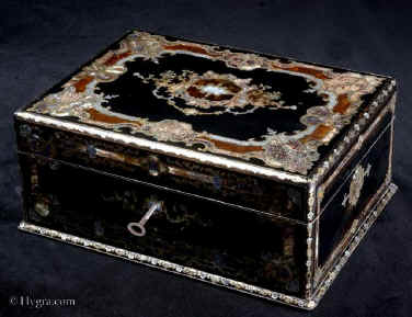 SB500: Antique opulent fully fitted sewing box in ebony profusely inlaid with tortoiseshell,  engraved brass, mother of pearl and abalone. The inside has  a silk covered lift out tray retaining a set of sewing tools  including turned and carved mother of pearl spools with matching tape measure and needle cleaner. A central tray has steel tools with tortoiseshell handles. Circa 1840.   Enlarge Picture