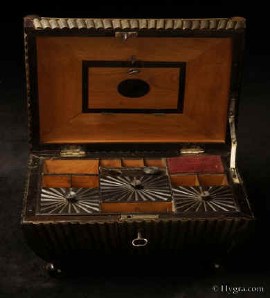 Anglo Indian Vizagapatam radiating black buffalo  horn  antique fitted sewing box of dramatic curved shape standing on turned horn feet having a lift out horn edged sandalwood tray with three further radiating horn lids. Circa  1820-1845. Enlarge Picture