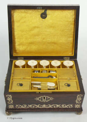 A fully fitted brass inlaid rosewood sewing box with gadrooned edges gilt side carrying handles and gilt feet. Inside the fully fitted sewing tray contains a set of turned ivory spools.  Circa 1810. Enlarge Picture