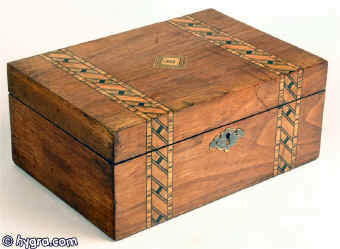  Box veneered in walnut and inlaid in strips of geometric marquetry of light and stained woods circa 1880.. Enlarge Picture