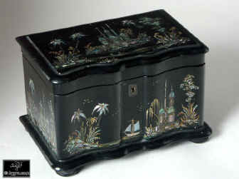 A serpentine fronted two compartment papier mch tea caddy decorated with chinoiserie painting on an iridescent pearl shell inlay. Enlarge Picture