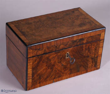 A twin compartment tea caddy veneered with highly figured burr walnut crossbanded with  kingwood and edged with ebony, the inside having twin supplementary lids of pyramid form. Circa 1860 Enlarge Picture