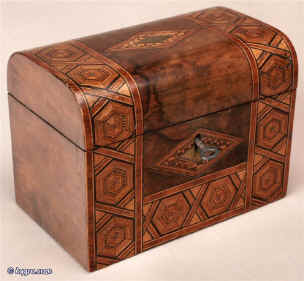 A Victorian walnut two compartment tea caddy with a domed top inlaid with a parquetry made of woods of several colors, the inside having twin compartments with supplementary lids, circa 1880 Enlarge Picture