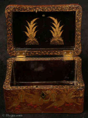 TC130:A Chinese export lacquer tea caddy in reddish earth colored lacquer having rounded corners decorated with two colors of gold depicting groups of birds highlighted in red lacquer. Circa 1840.Enlarge Picture