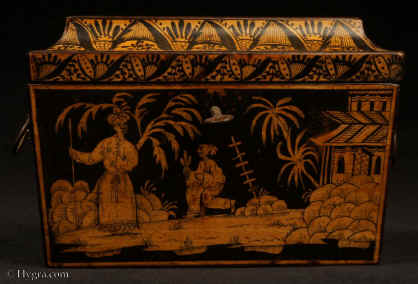 TC533:A two compartment penwork tea caddy with quirky exotic scenes depicting imagined eastern figures in the land of Cathay. The cavetto  molding is decorated with repeating palmette in a fluid hand more suited to the overall design  of the caddy than the more rigid neo classical . Inside there are two lidded compartments still  retaining remnants of their original leading. The caddy retains its original hardware such as hinges lock and embossed brass ring handles in the form of baskets of flowers. circa 1830. Enlarge Picture