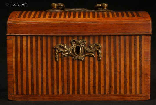TC537:18th century tea caddy with domed top  the oak carcass veneered with a parquetry of rosewood and satinwood  in alternating stripes. framed by a crossbanding in kingwood.  The escutcheon is gilded bronze.  The inside is lined with lead foil. There is a single lid which would sit on the tea in the 18th century manner. Circa 1770. Enlarge Picture