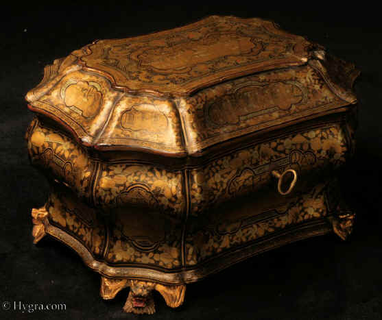 TC581:A curvaceous Chinese export lacquer tea chest with undulating sides decorated with two colours of gold depicting scenes of of Oriental life opening to a single compartment containing two lidded pewter tea canisters with supplementary inner lids, the whole chest standing on feet in the form of dragon heads. Circa 1840. Enlarge Picture