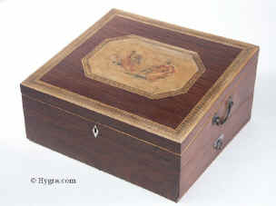 An early 19th century partridgewood writng box with inlaid banding and decorated with a hand coloured  engraving depicting a  winged Victory ahead of a Classical  laurelled hero riding in his chariot, having side carrying handles a drawer, inner velvet writing surface and places for writing materials and accessories. Enlarge Picture