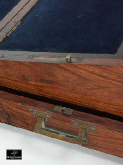A brass bound solid rosewood  writing box with side drawer, secret drawers, countersunk carrying handles a pair of inkwells .Enlarge Picture